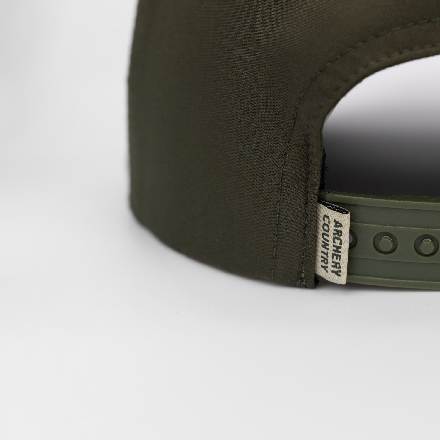 closeup of rear view of faded olive hat showing "ARCHERY COUNTRY" label