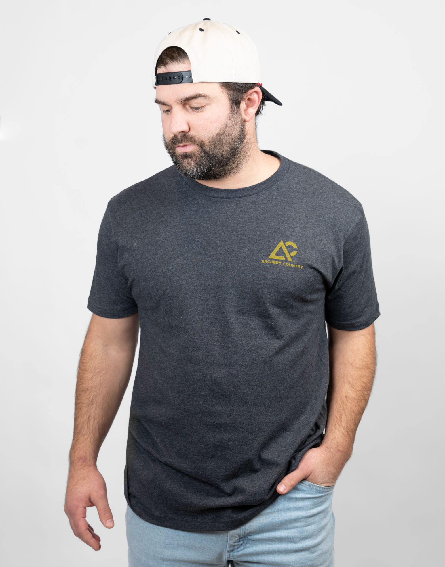 Man wearing charcoal tee with small Archery Country logo on left chest