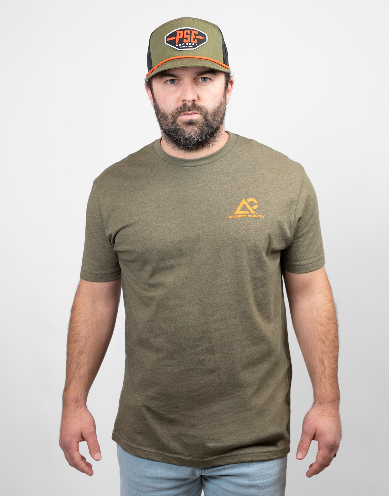 Man wearing military green tee with small Archery Country logo on left chest