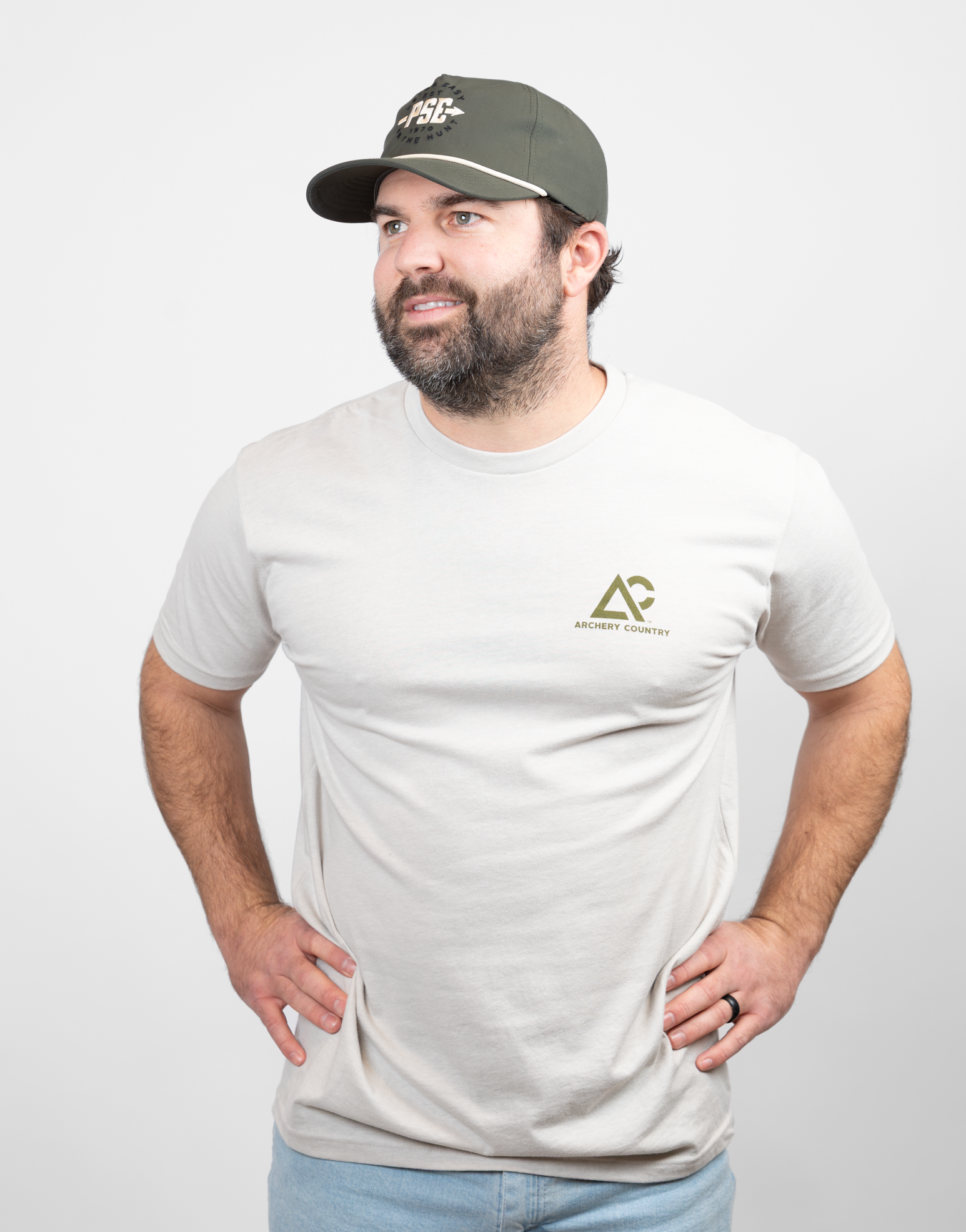 Man wearing heather sand tee with small Archery Country logo on left chest