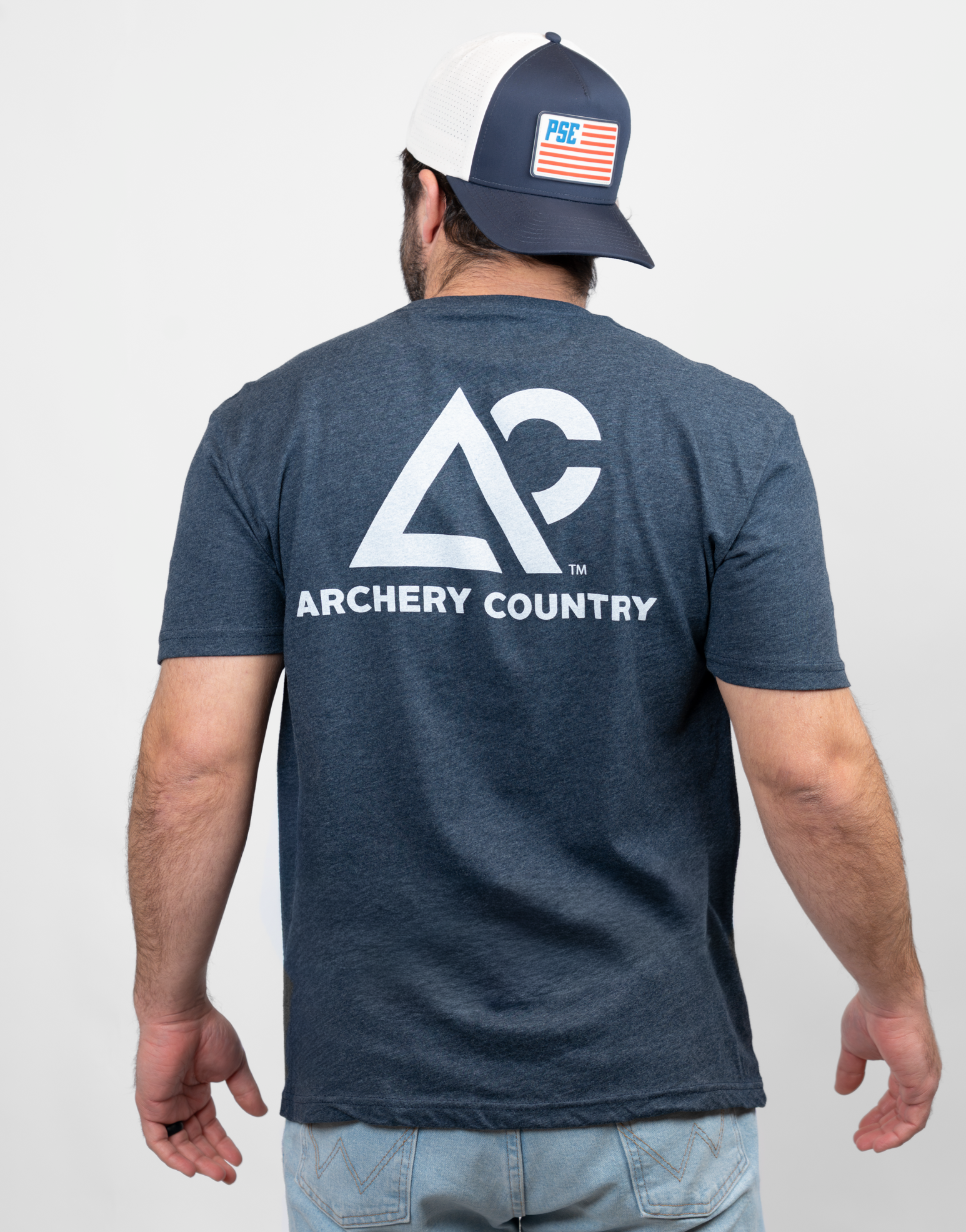 Rear view of man wearing heather navy tee with "Archery Country" logo on back