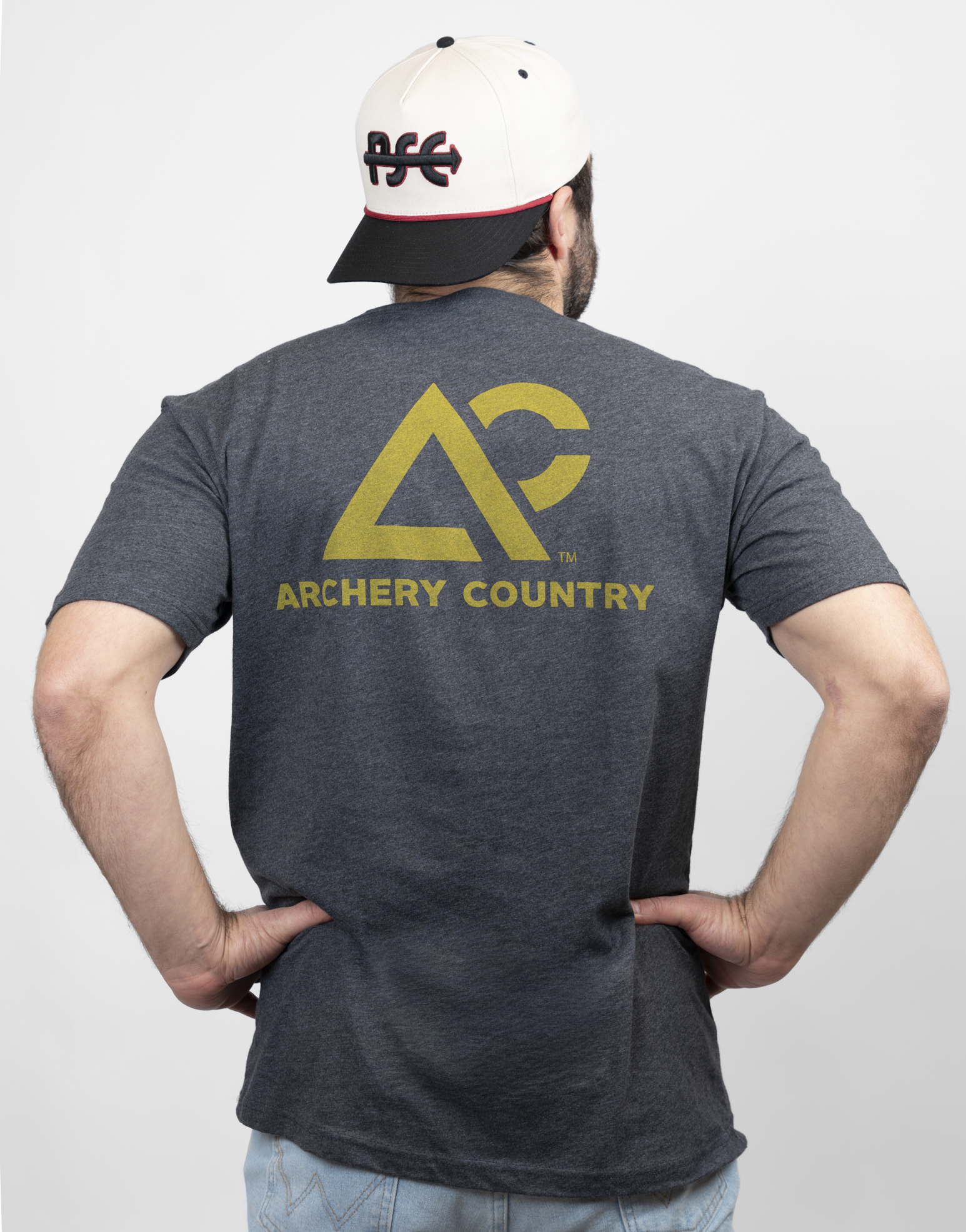 Rear view of man wearing charcoal tee with "Archery Country" logo on back