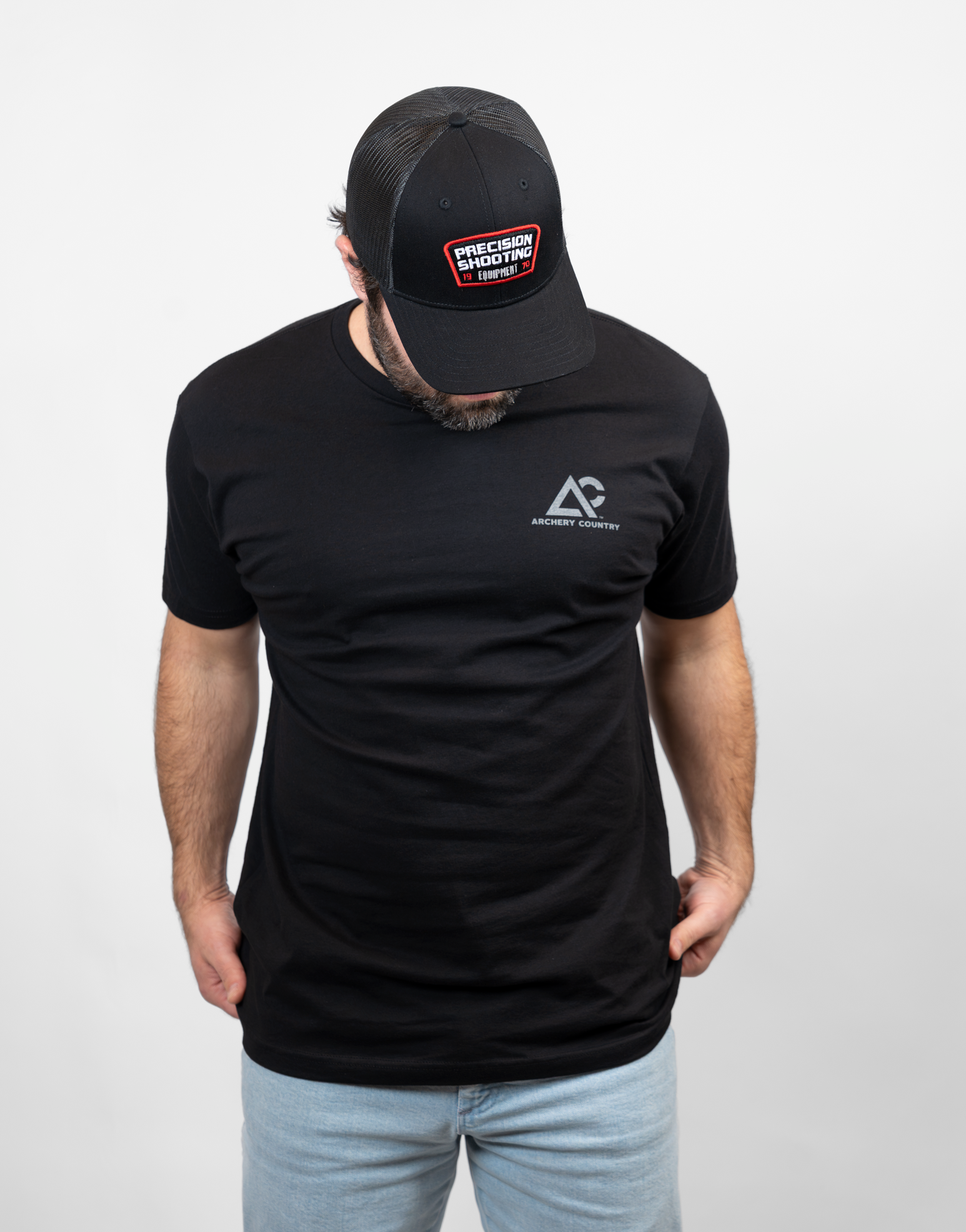 Man wearing black tee with small Archery Country logo on left chest