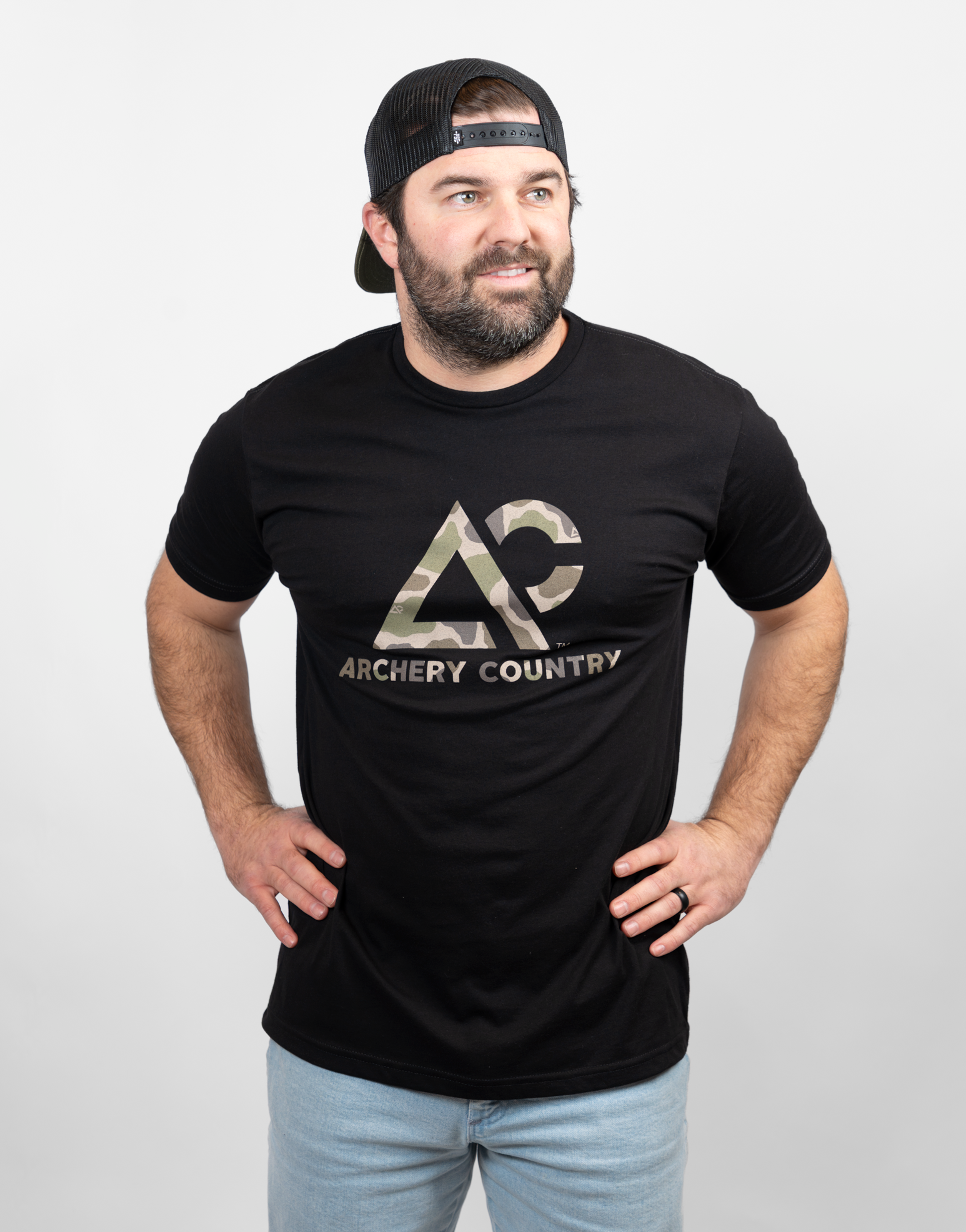 Man wearing black tee with camo "ARCHERY COUNTRY" logo on chest