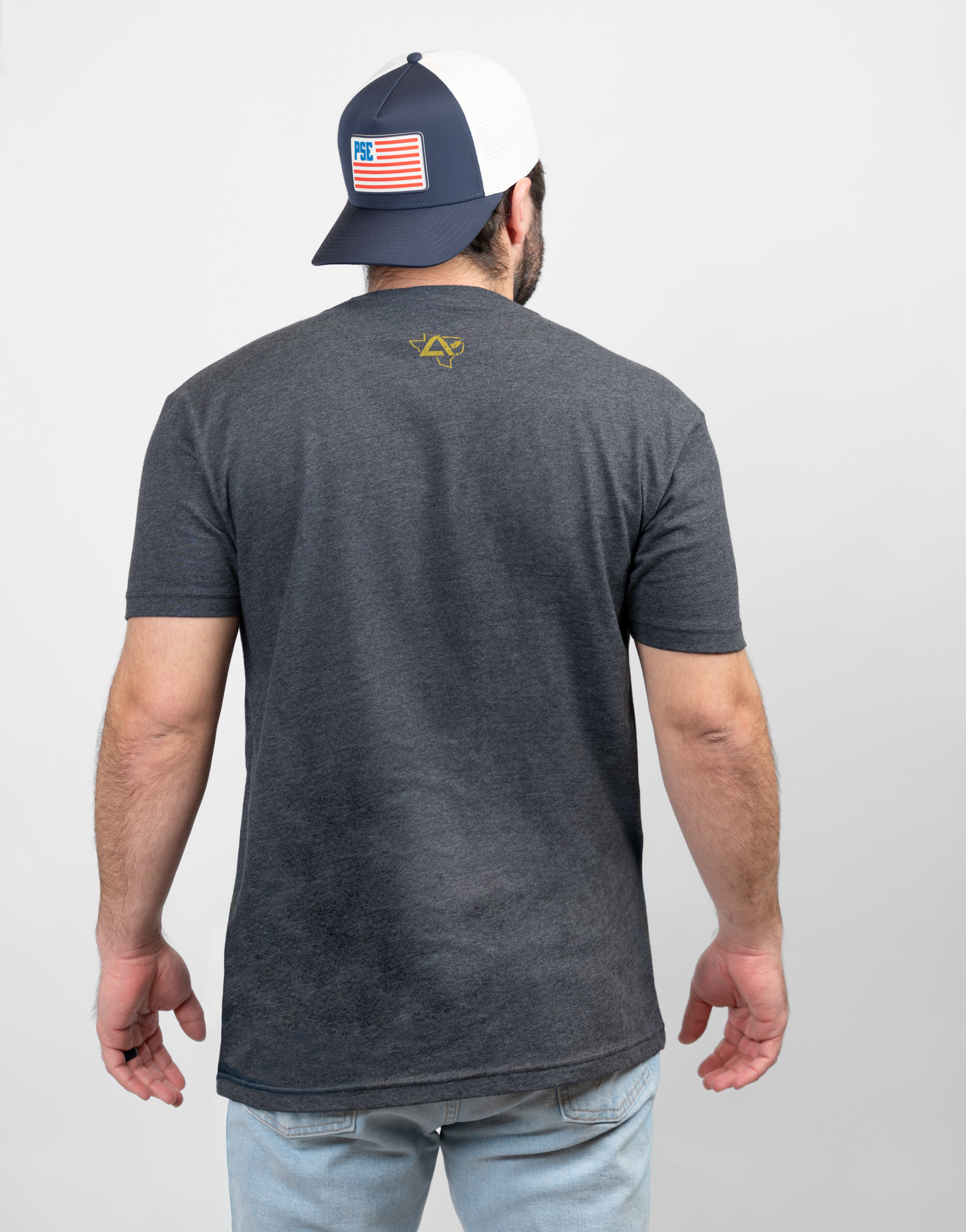 Rear view of man wearing charcoal shirt with Texas Archery Country logo on upper back