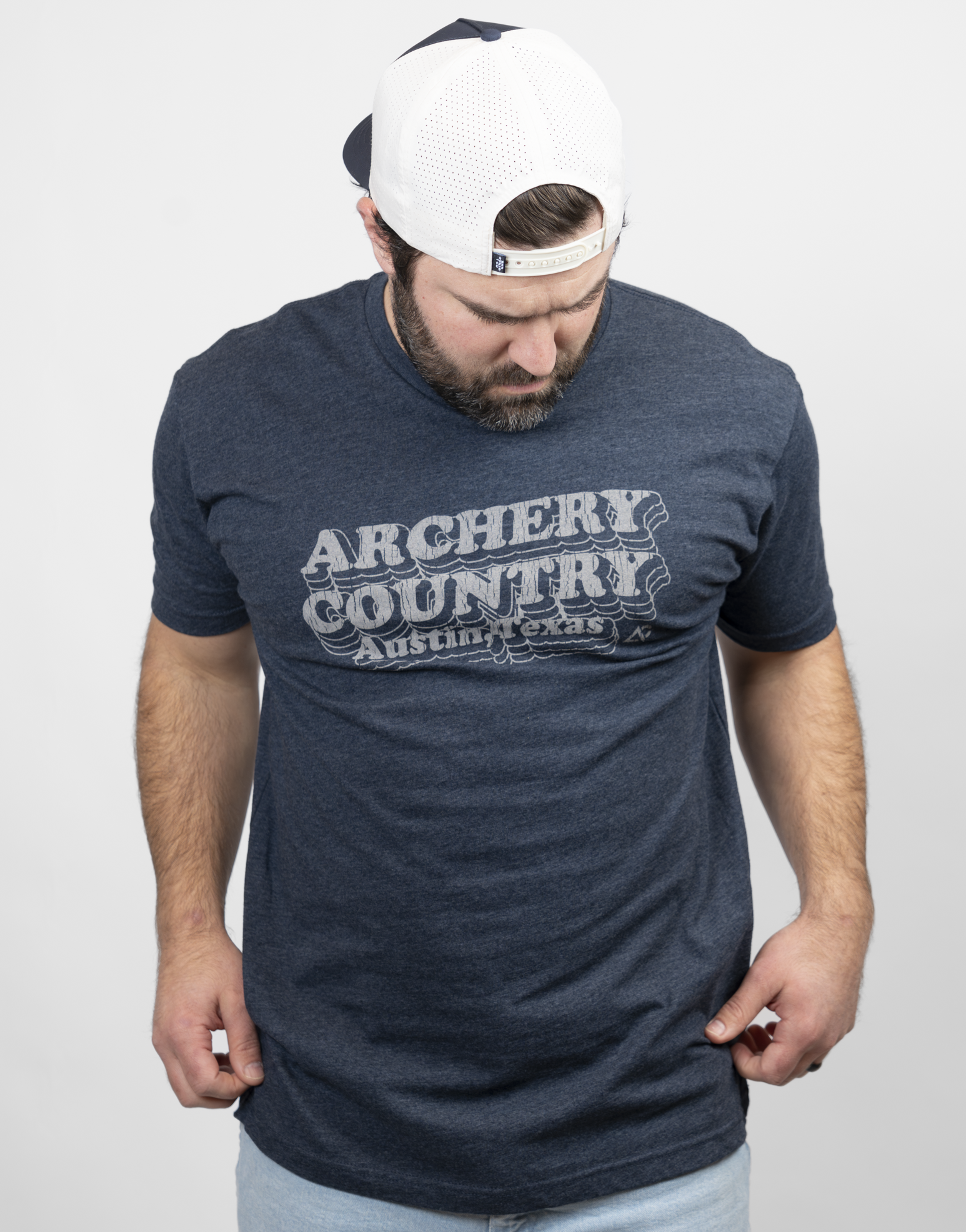 Man wearing heather navy tee with text "ARCHERY COUNTRY Austin, Texas"