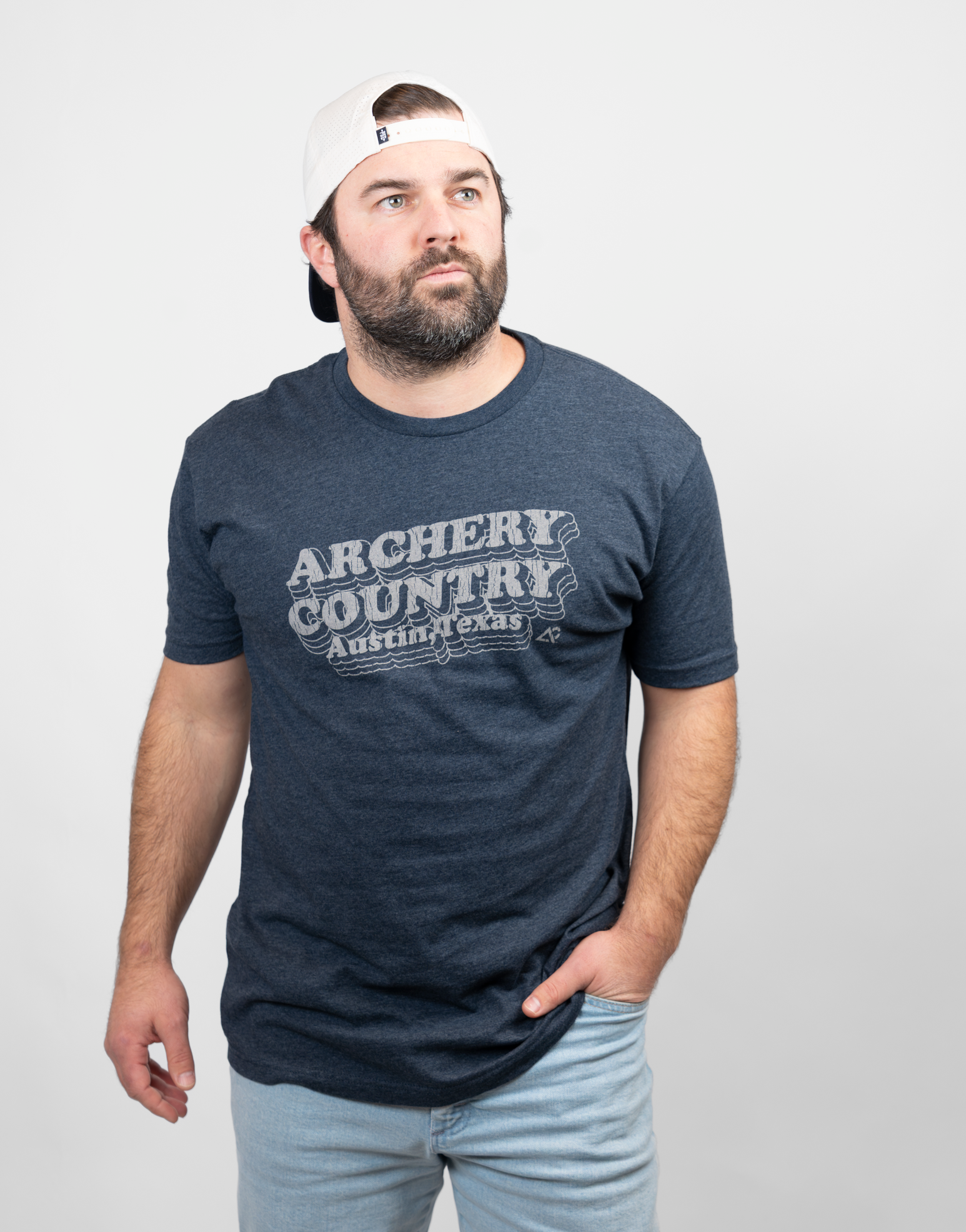 Man wearing heather navy tee with text "ARCHERY COUNTRY Austin, Texas"