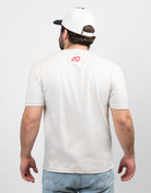 rear view of mand wearing sand tee with red Archery Country logo on upper back
