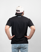 rear view of man wearing black tee with "ARCHERY COUNTRY" text on upper back