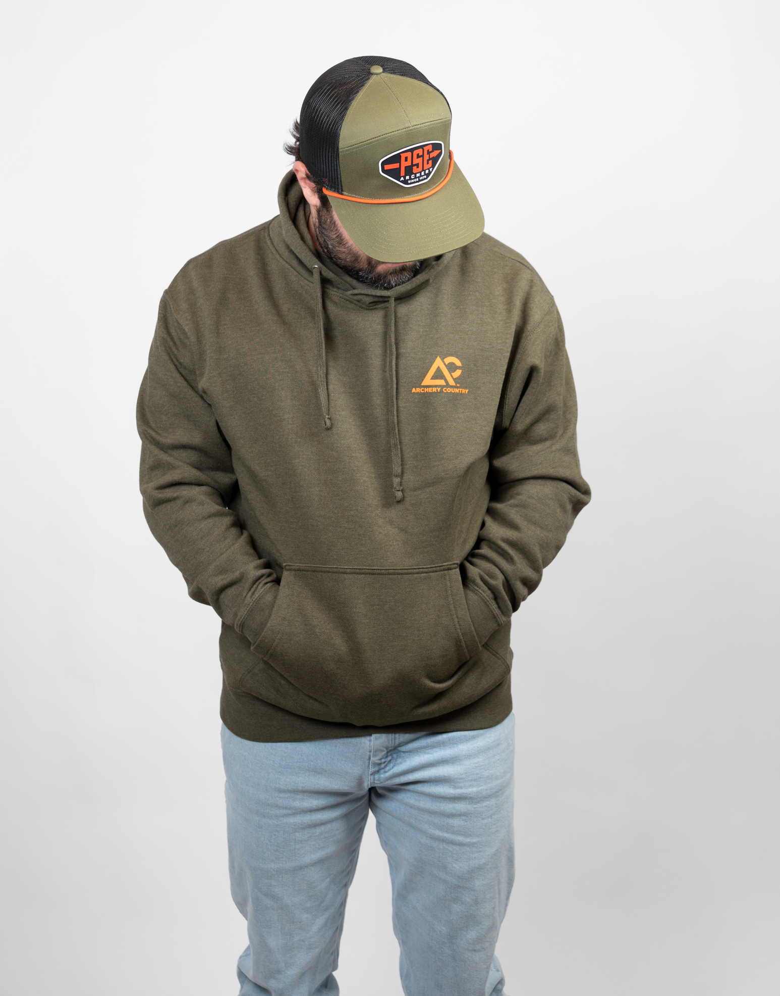Man wearing a green hoodie with an orange Archery country logo on left chest