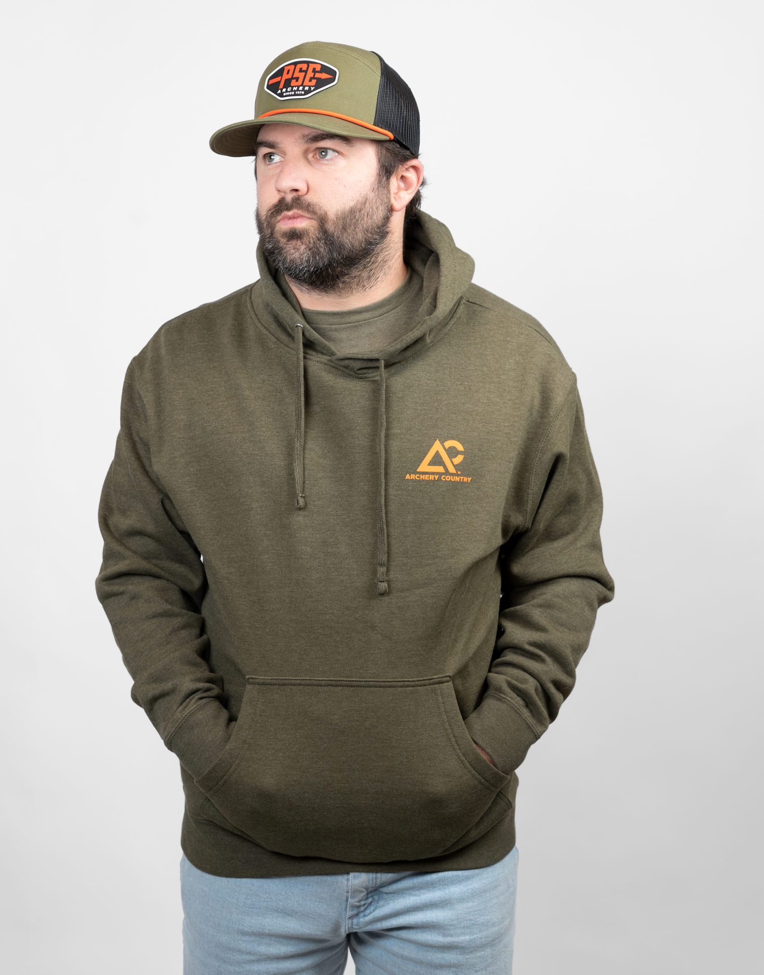 Man wearing a green hoodie with an orange Archery country logo on left chest
