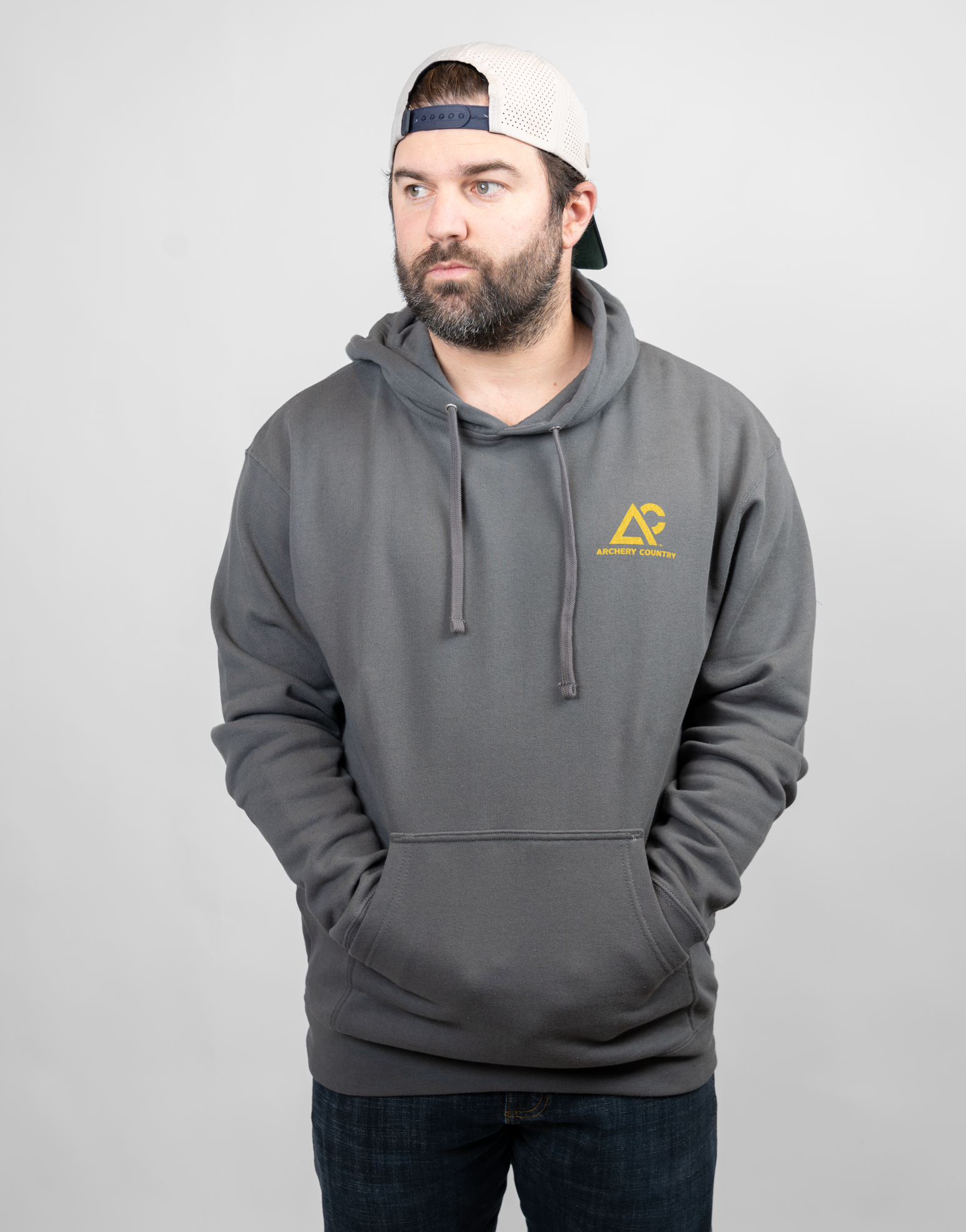 Man wearing charcoal hoodie with Archery Country logo on left chest