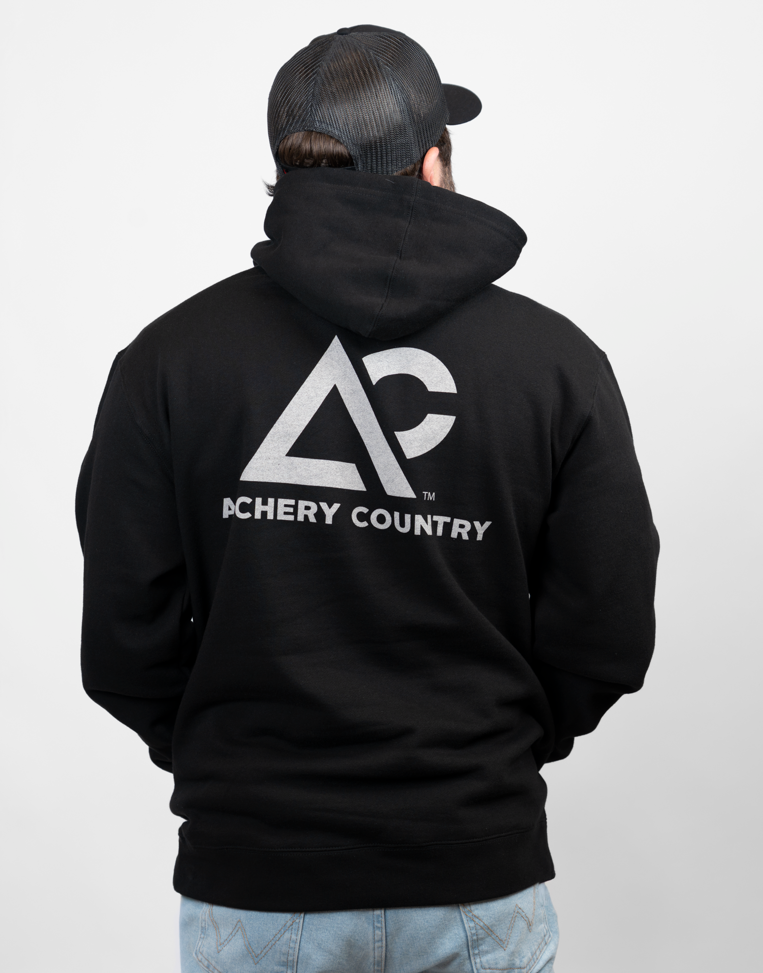 man wearing black hoodie with large Archery Country logo on back