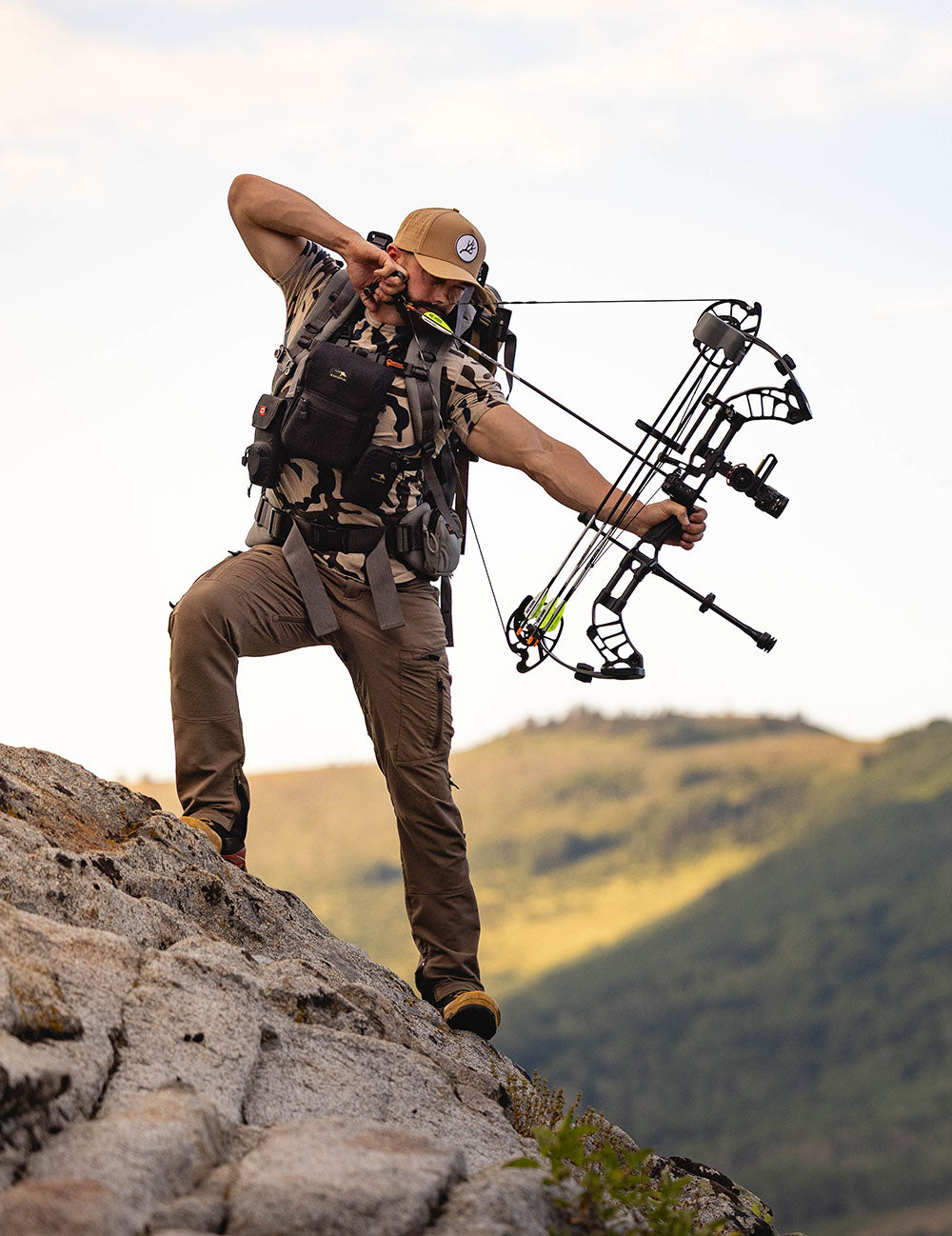 Man with a bow and arrow on a mountain